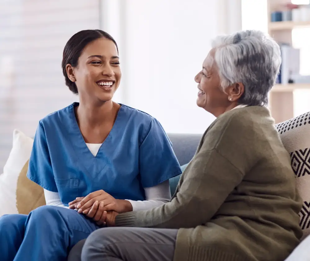 To-see-you-smile-means-Im-doing-my-job-well.-a-young-nurse-chatting-to-a-senior-woman-in-a-retirement-home-scaled